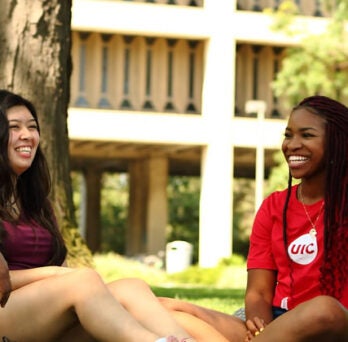 Students sitting on east lawn 